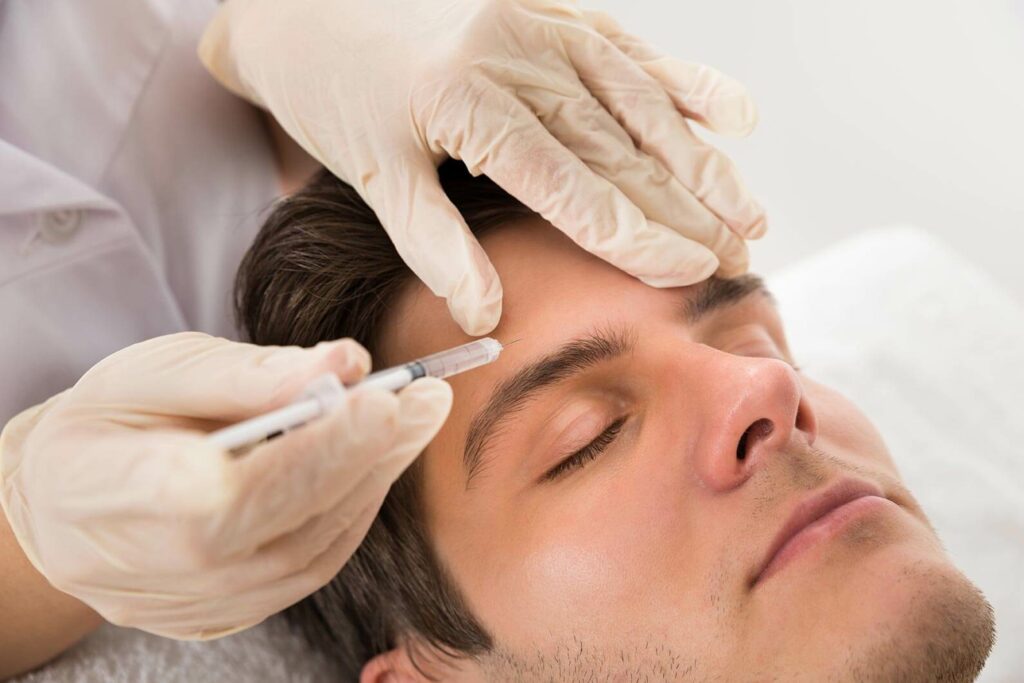 Man getting a rejuvenating injection into his forehead